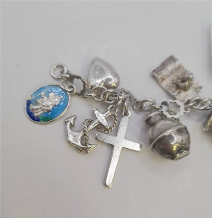 Silver charm bracelet with intricate designs, weighing 45.9g, featuring various decorative charms and a secure clasp.