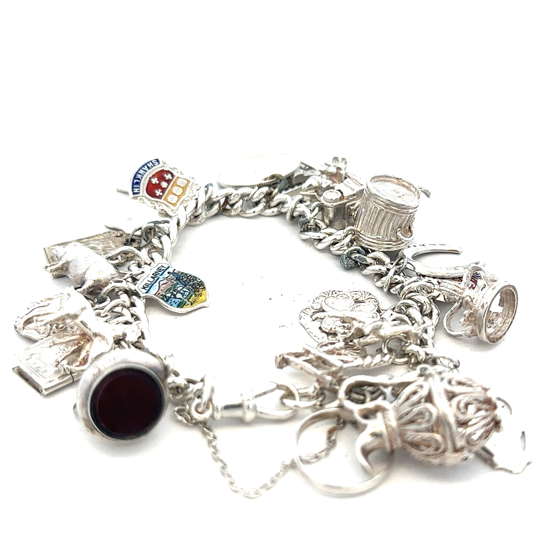 Silver charm bracelet weighing 61g with various charms, featuring a sleek design and adjustable chain, unbranded jewelry accessory