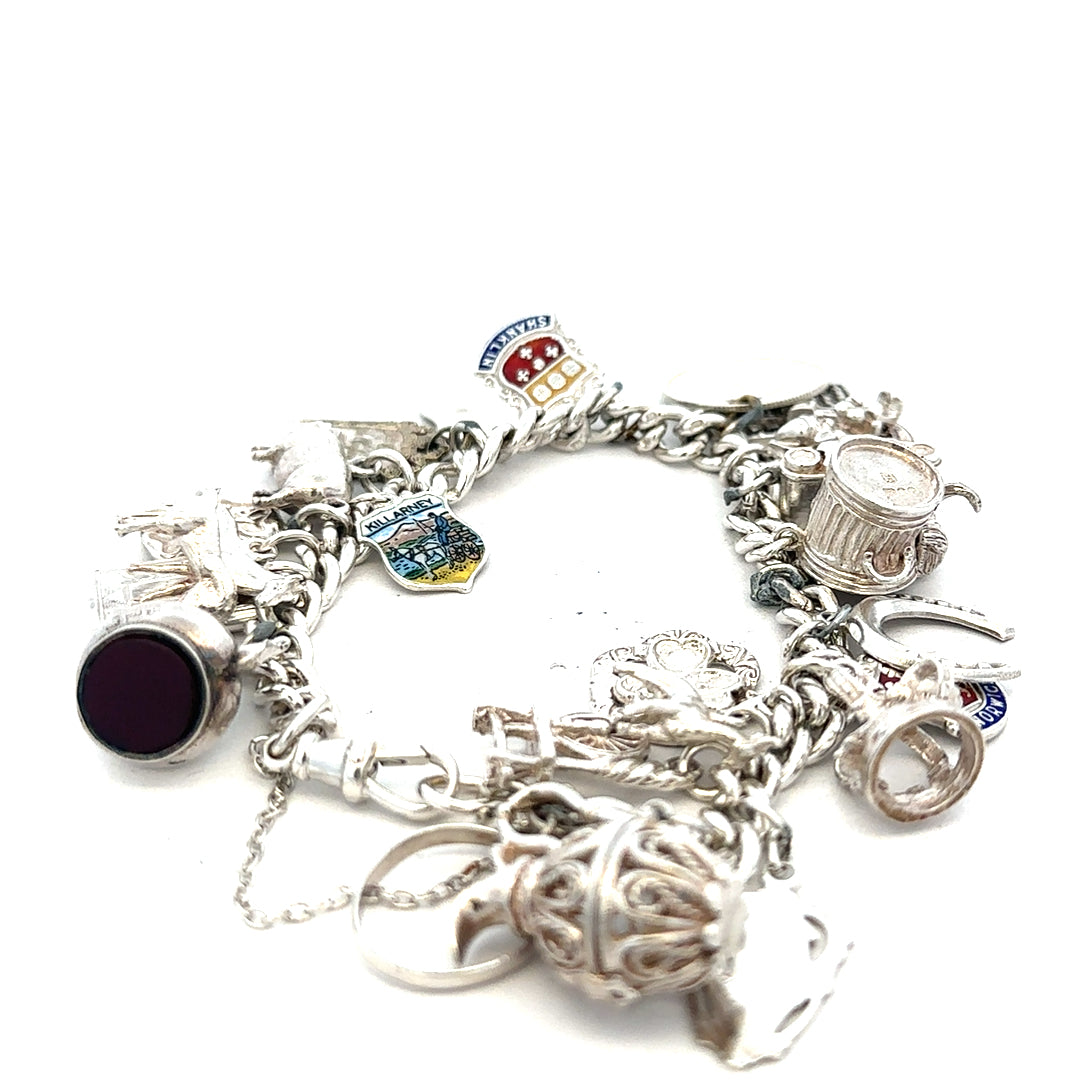 Silver charm bracelet with intricate designs, weight 61g, featuring various decorative charms and a secure clasp.
