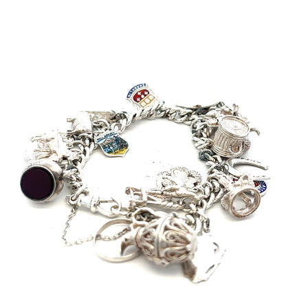 Silver charm bracelet with intricate designs, weight 61g, featuring various decorative charms and a secure clasp.