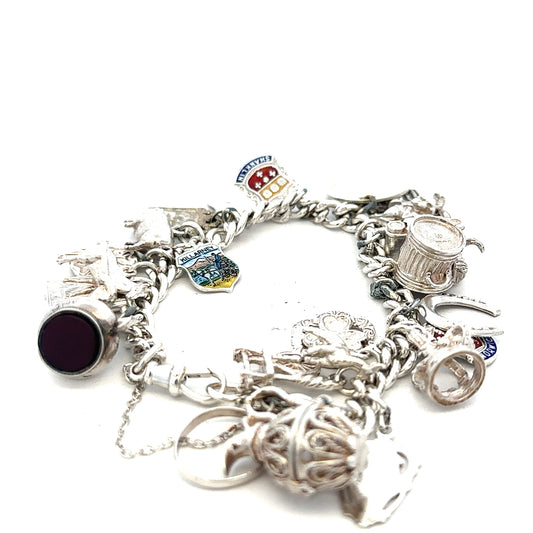 Silver charm bracelet with intricate designs, weight 61g, featuring various decorative charms and a secure clasp.