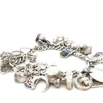 Silver charm bracelet with intricate designs, weighing 61g, featuring multiple charms and a secure clasp.