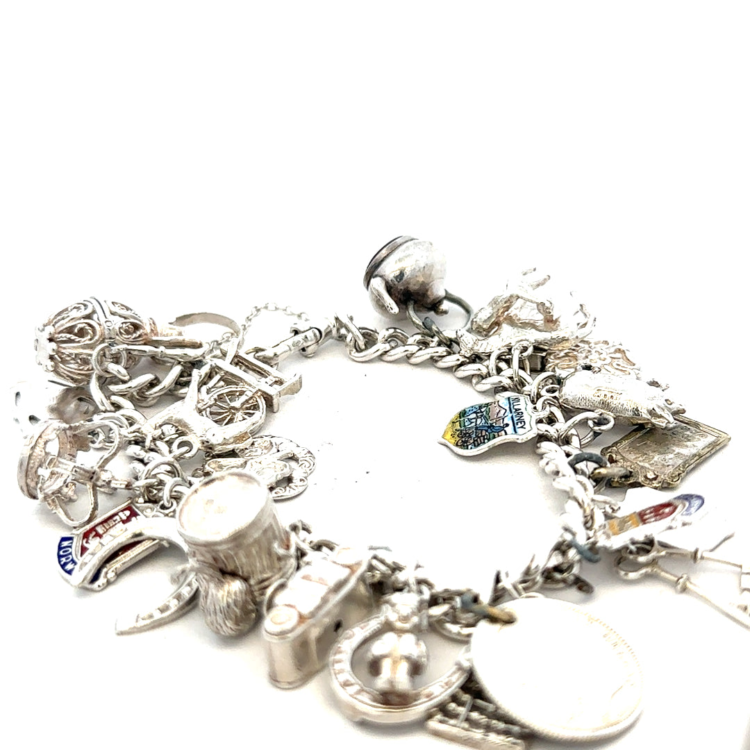 Silver charm bracelet weighing 61g with various decorative charms, crafted for a stylish and elegant look.