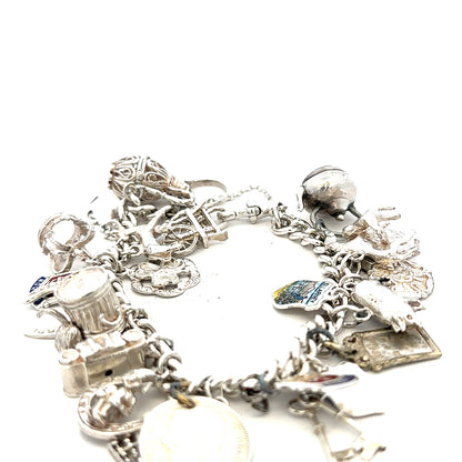 Silver charm bracelet weighing 61g with various decorative charms, unbranded jewelry accessory.