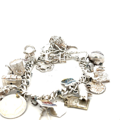 Silver charm bracelet weighing 61g with various charms, featuring a sleek and elegant design, perfect for stylish accessories.