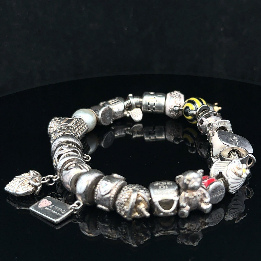 Silver charm bracelet with various charms, featuring a 64.8 cm length, unbranded jewelry accessory for stylish wristwear.