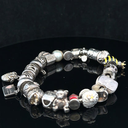 Silver charm bracelet with multiple decorative charms, featuring a 64.8 cm length, unbranded jewelry accessory.