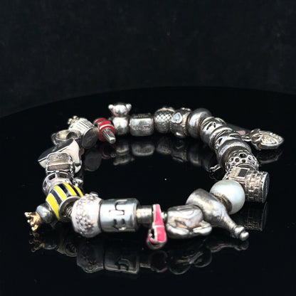 Silver charm bracelet with various decorative charms, 64.8 cm length, unbranded, stylish jewelry accessory for women