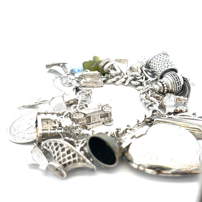 Silver charm bracelet weighing 83.4g with various charms, stylish jewelry accessory, unbranded fashion bracelet.