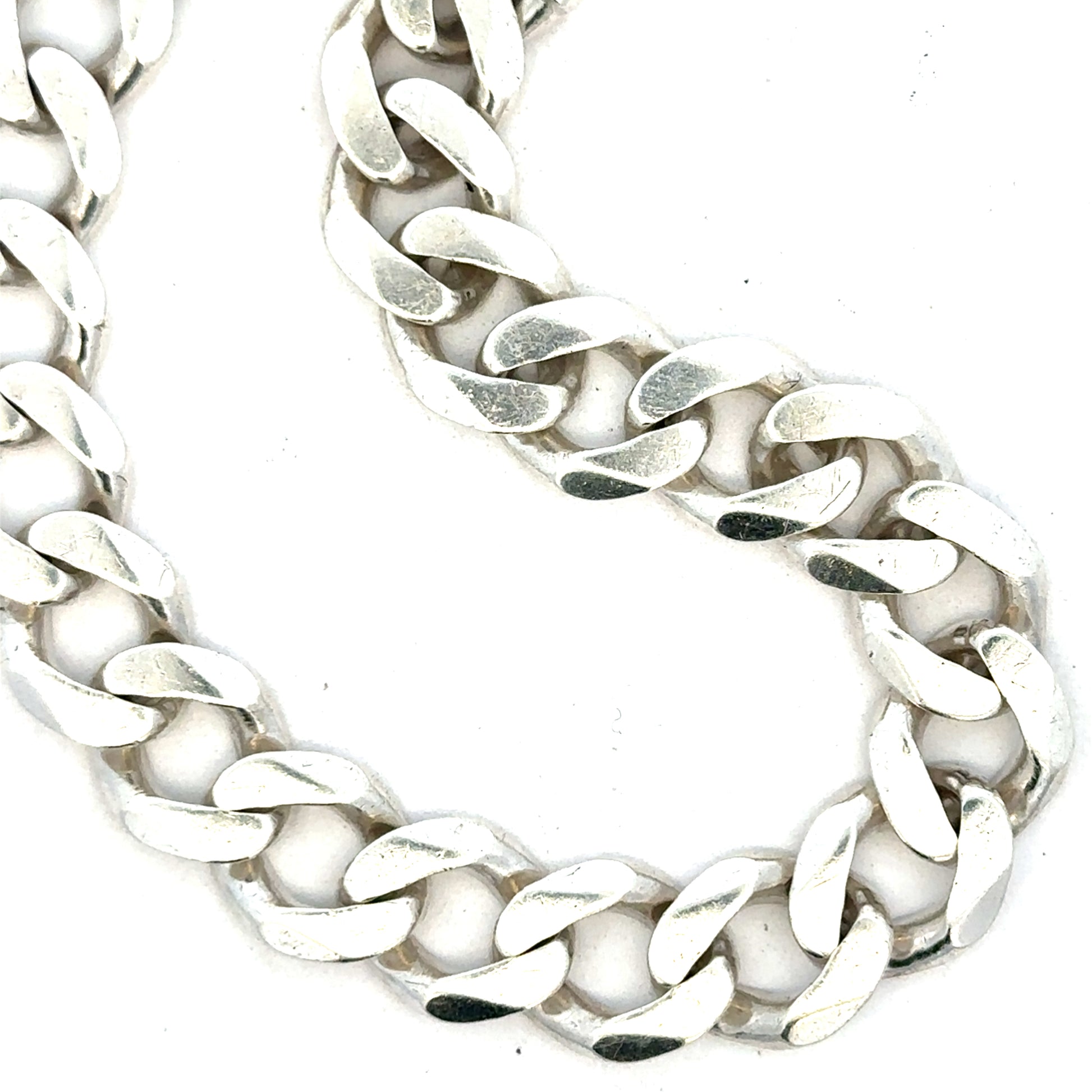 Silver curb bracelet weighing 33.7g, showcasing a sleek chain design with a polished finish, unbranded jewelry accessory.