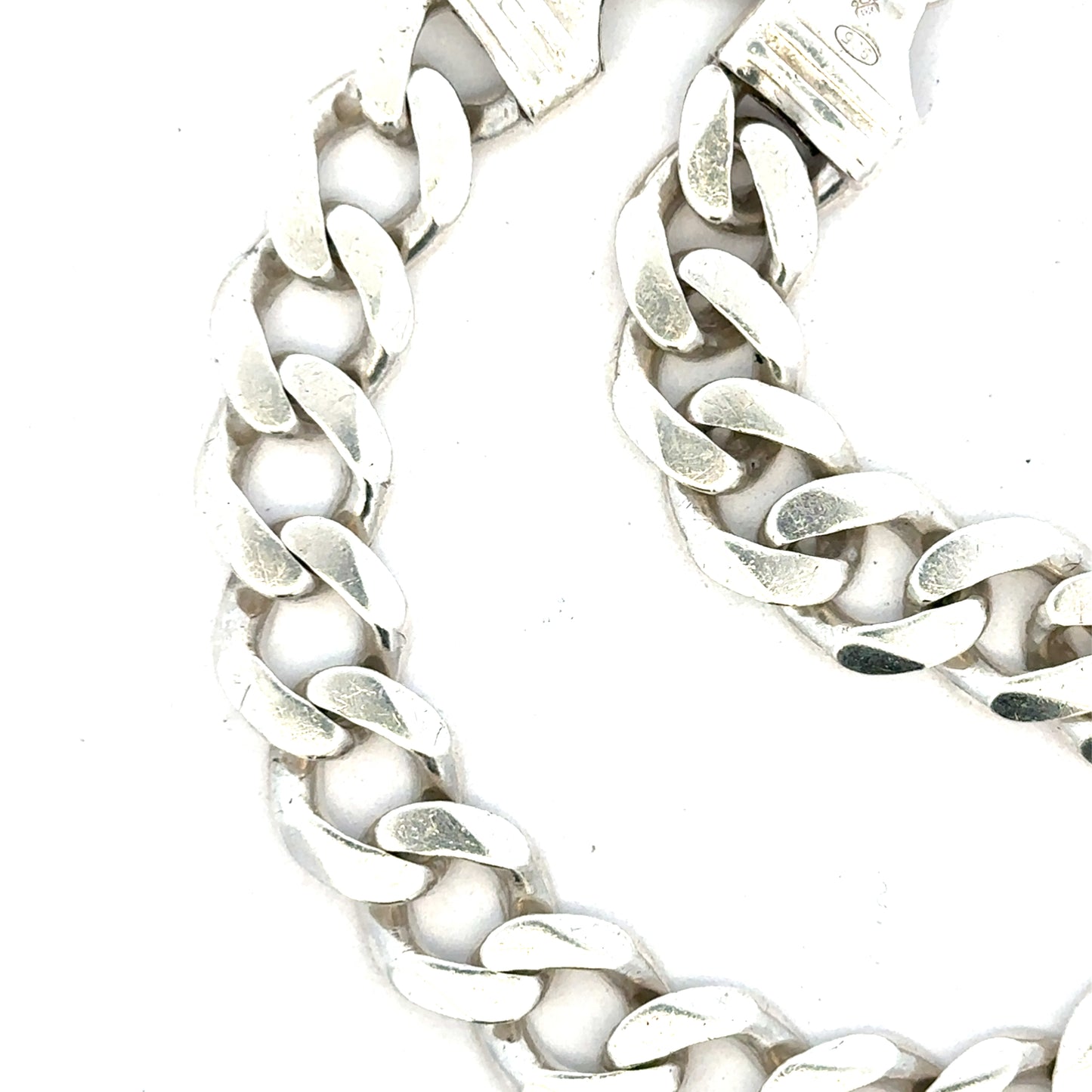 Silver curb bracelet weighing 33.7g, featuring a classic chain design, shown in a close-up image highlighting its polished finish.