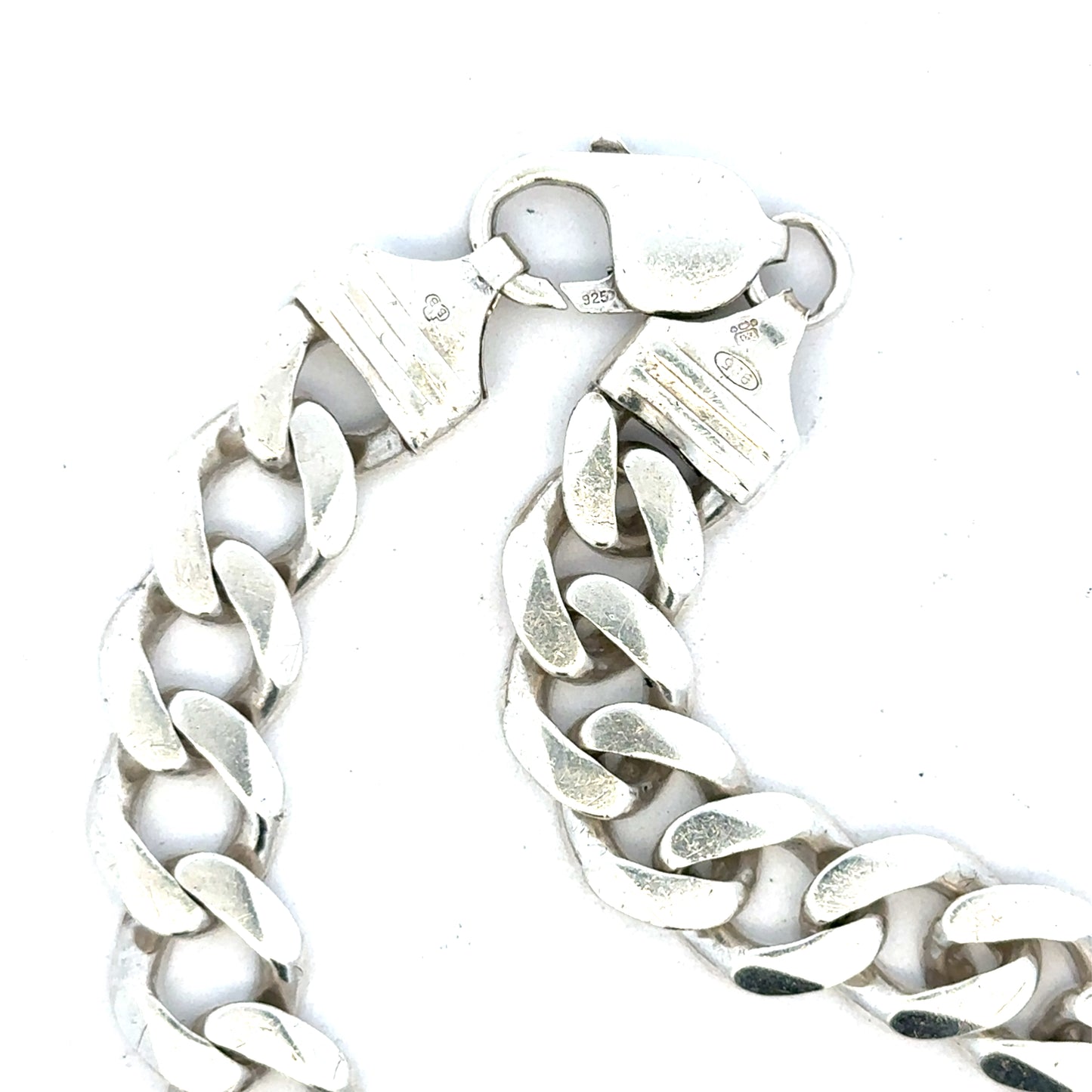Silver curb bracelet weighing 33.7g, unbranded jewelry with a sleek, polished chain design, shown in a close-up image.