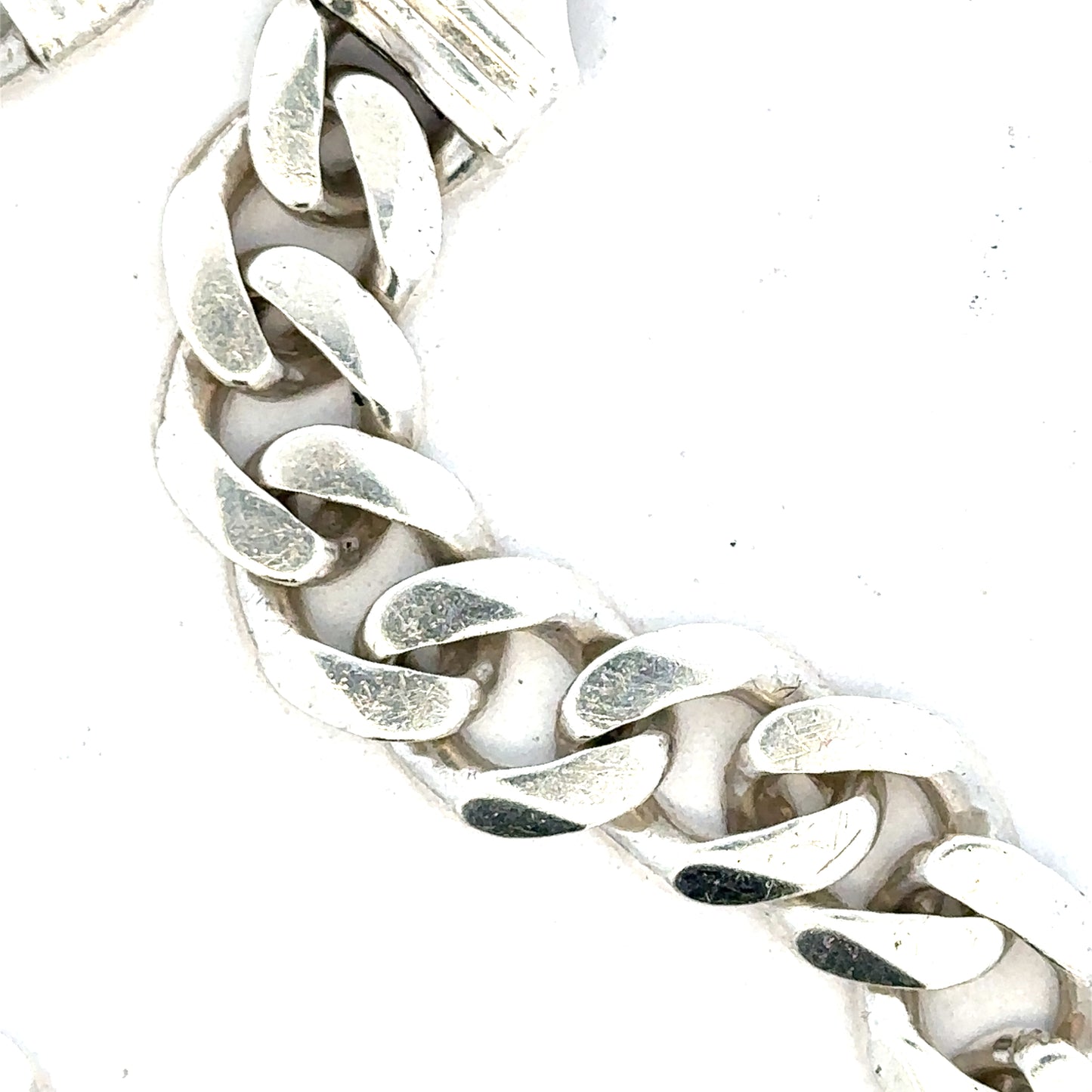Silver curb bracelet weighing 33.7g with a sleek, linked design, displayed on a neutral background.