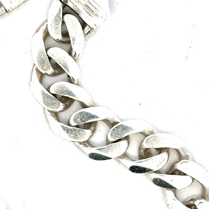 Silver curb bracelet weighing 33.7g with a sleek, linked design, displayed on a neutral background.