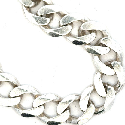 Silver curb bracelet weighing 33.7g, featuring classic linked chain design, unbranded jewelry accessory.