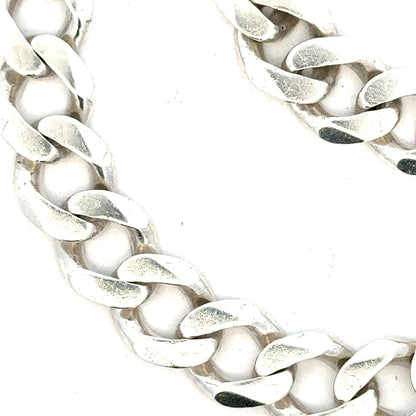 Silver curb bracelet weighing 33.7g, unbranded, showcasing a sleek chain design with polished links.