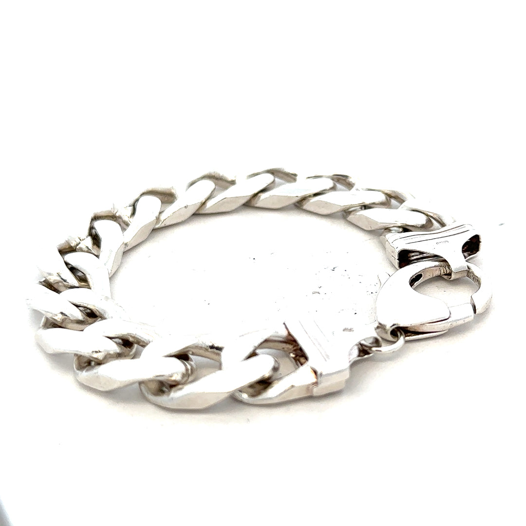Silver curb bracelet weighing 81.4g, featuring a sleek chain design, displayed in a natural pose.