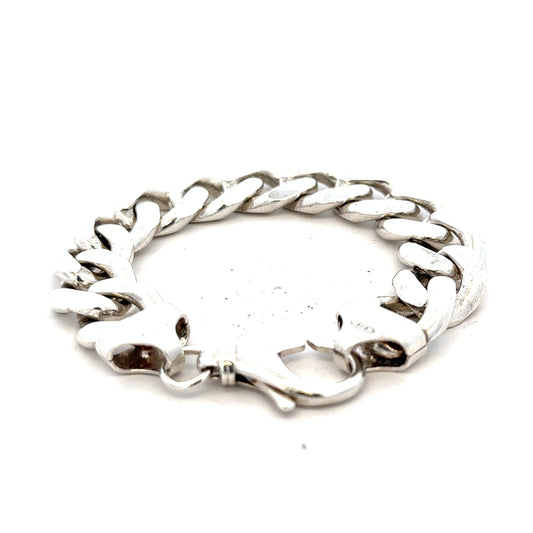 Silver curb bracelet weighing 90.1g with a sleek chain design, featuring a shiny, polished finish.