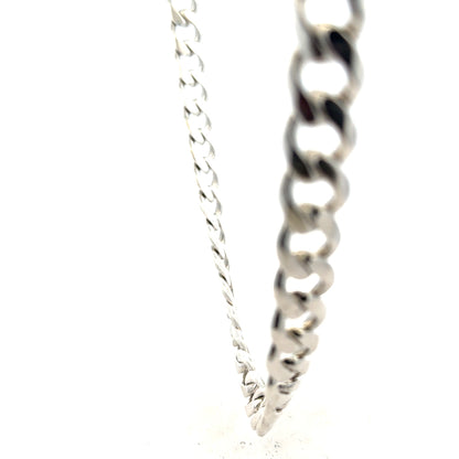 Silver curb chain weighing 115.4g, unbranded jewelry chain with a sleek, polished finish and interlocking links.