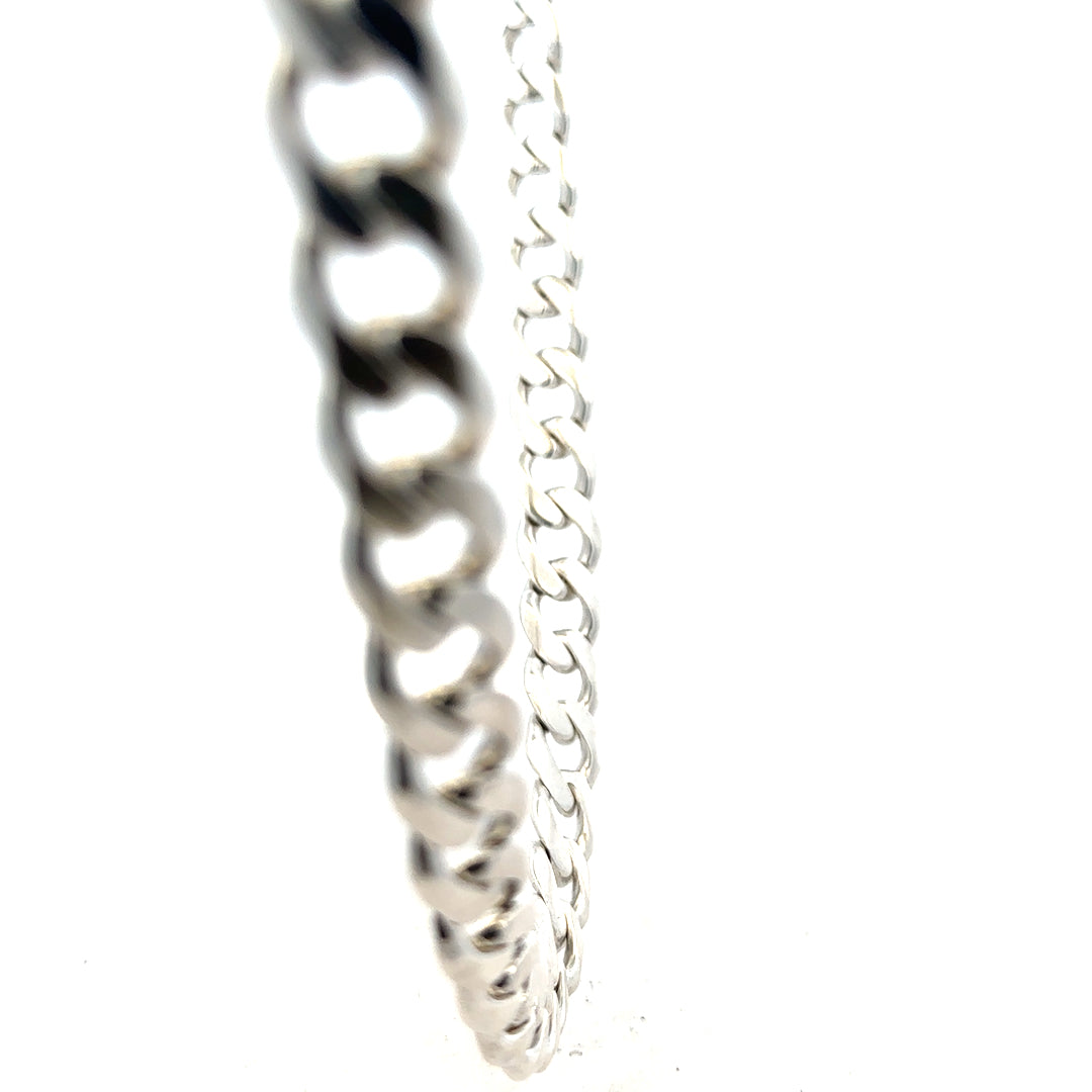 Silver curb chain weighing 115.4g, featuring a classic design with interconnected oval links, ideal for jewelry making or wear.