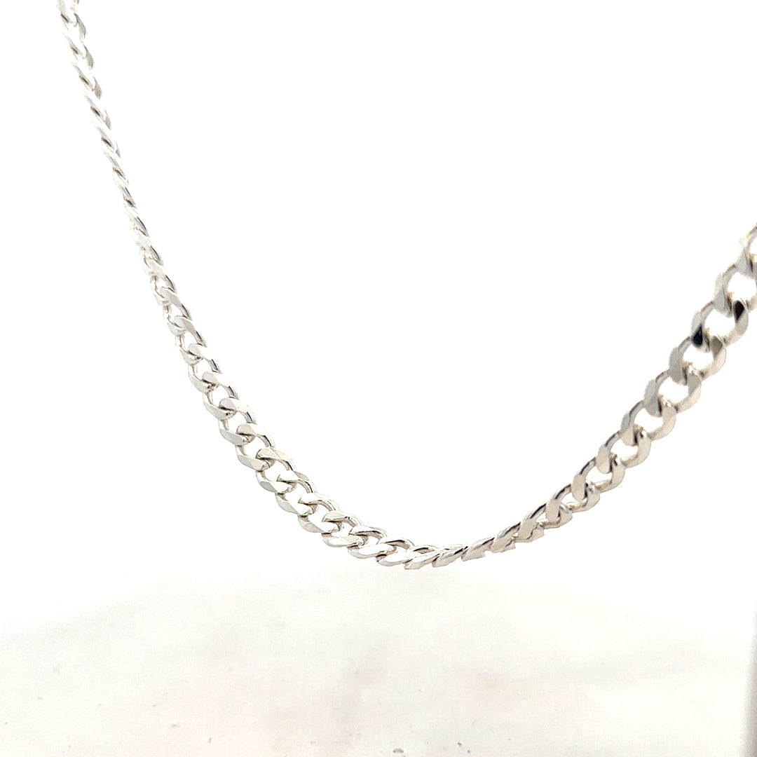 Silver curb chain weighing 27.8g, featuring a classic design, shown laid flat with a shiny metallic finish.