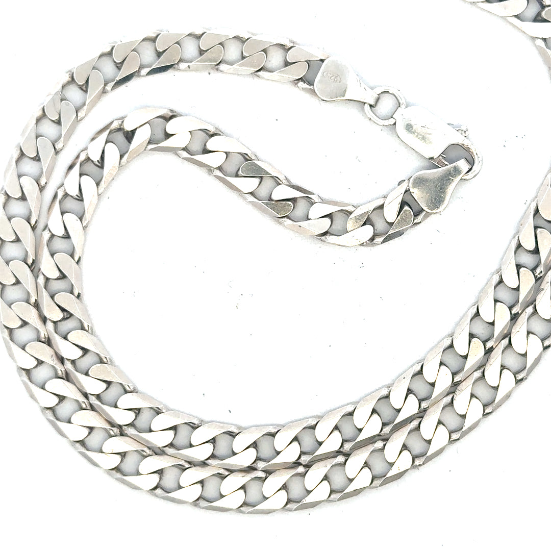 Silver curb chain weighing 31.3g, featuring interlocking links, shown in a close-up image highlighting its shine and chain links.