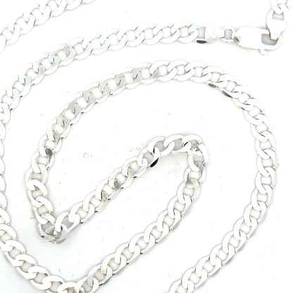 Silver curb chain weighing 34.5g, unbranded jewelry accessory, close-up of the polished silver chain links.