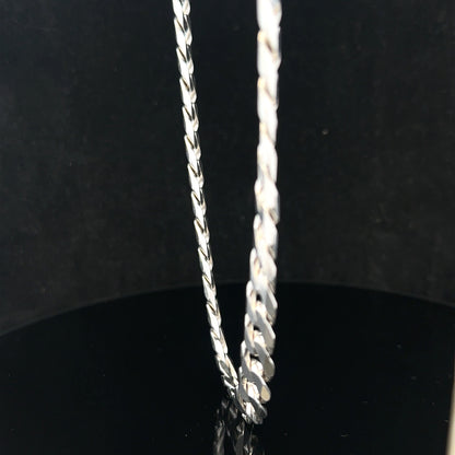 Silver curb chain weighing 60.4g, showcasing its thick links and shiny finish, ideal for jewelry or accessory use.