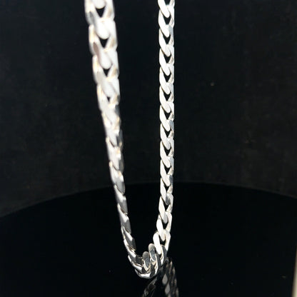 Silver curb chain weighing 60.4g, featuring classic linked design, displayed on a neutral background.