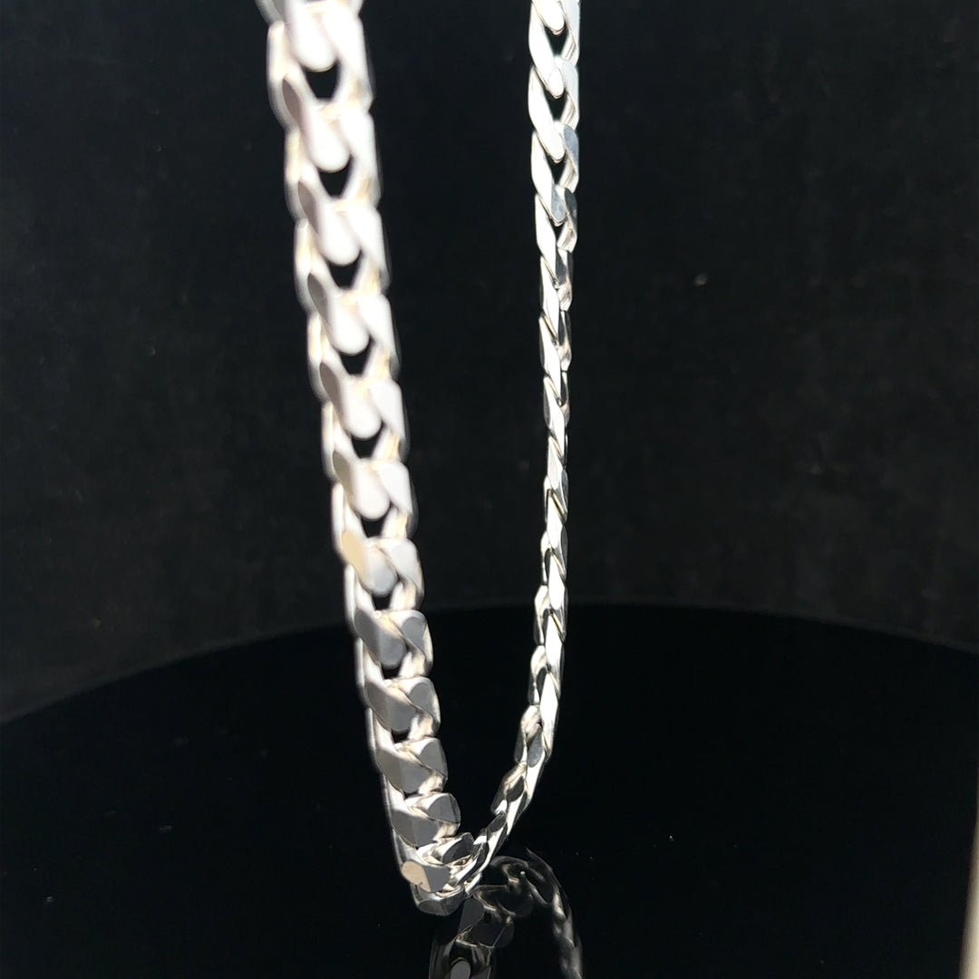 Silver curb chain weighing 60.4g, featuring interlocking flat links, displayed in a close-up shot.