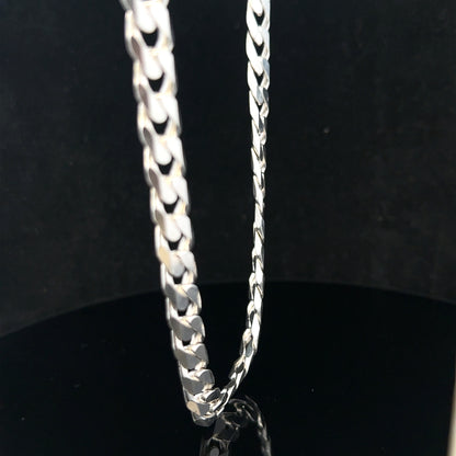 Silver curb chain weighing 60.4g, featuring interlocking flat links, displayed in a close-up shot.