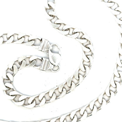 Silver curb chain weighing 63.4g, featuring a classic design with interlocking links, perfect for jewelry accessories.