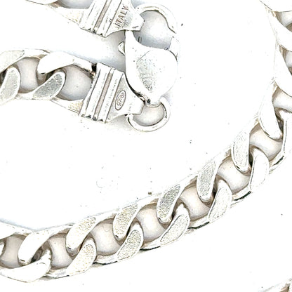 Silver curb chain weighing 63.4g, displayed on a plain background, showcasing its polished links and durable design.