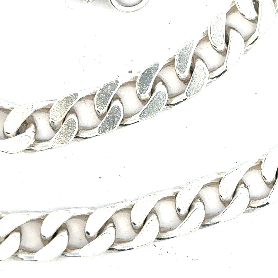 Silver curb chain weighing 63.4g with a classic design, featuring interlinked oval links, unbranded jewelry accessory.
