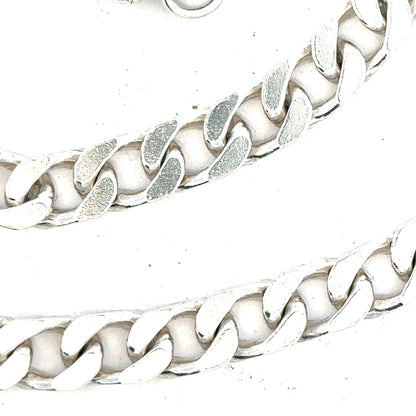 Silver curb chain weighing 63.4g with a classic design, featuring interlinked oval links, unbranded jewelry accessory.