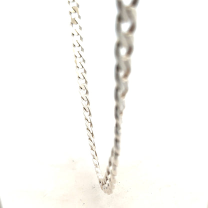 Silver curb chain weighing 66.7g, featuring a classic design, shown in a close-up view highlighting its links and polished finish.