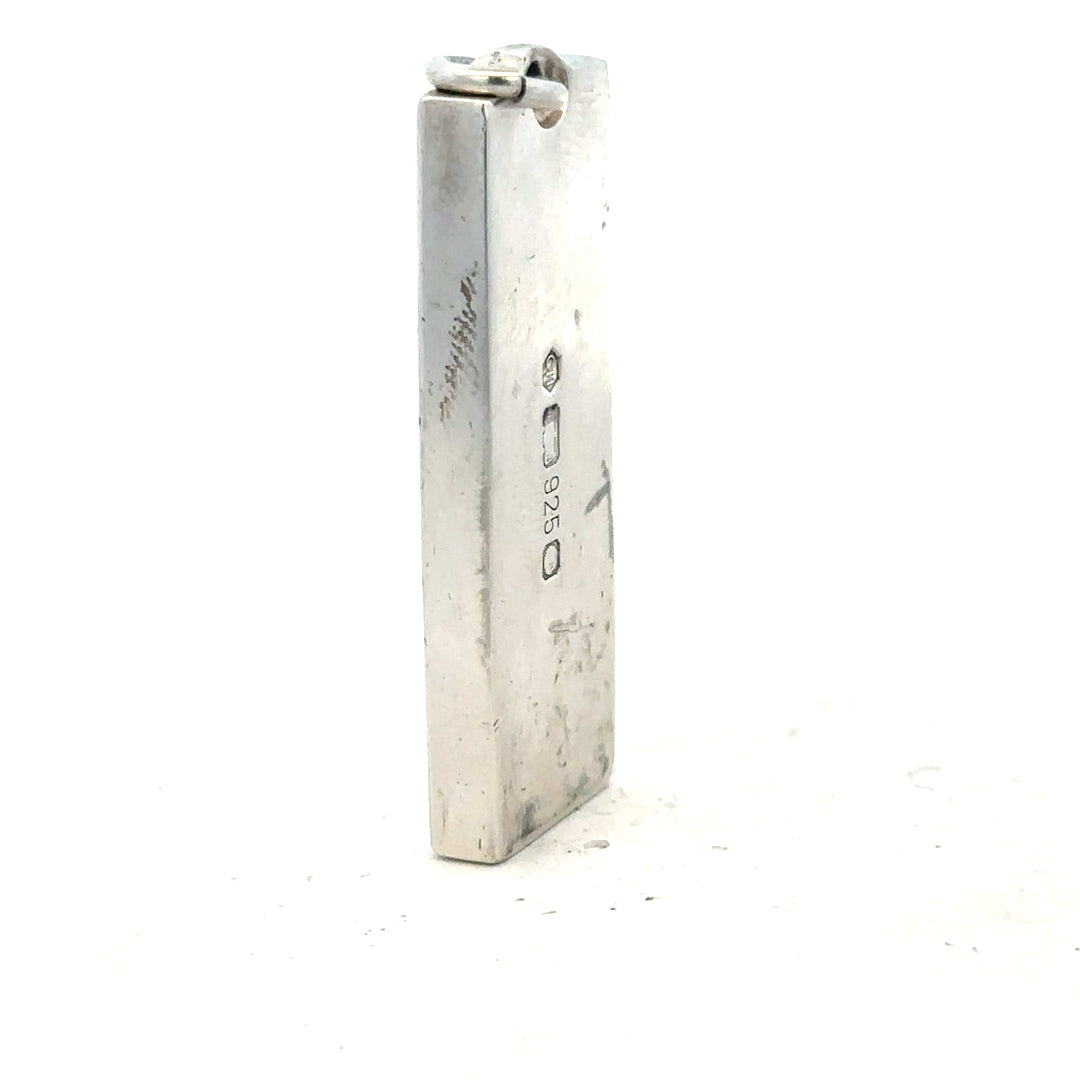 Silver ingot pendant, 31g, unbranded, detailed close-up showing polished silver surface and pendant shape.