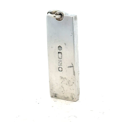 Silver ingot pendant weighing 31g, unbranded jewelry piece with a polished metallic finish and rectangular shape.