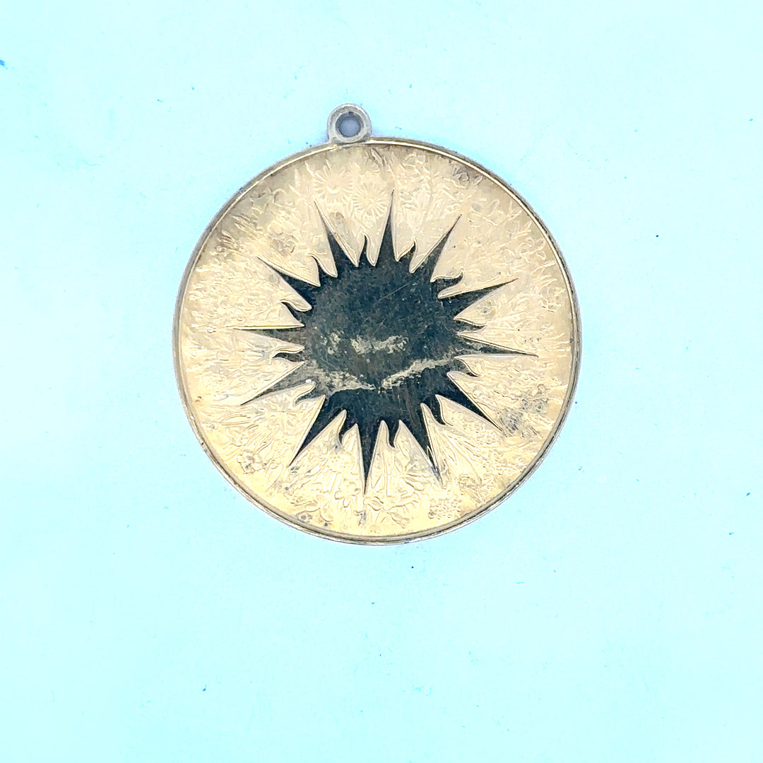 Silver pendant weighing 25.4g, showcasing a sleek and polished design with a smooth surface and elegant shape.