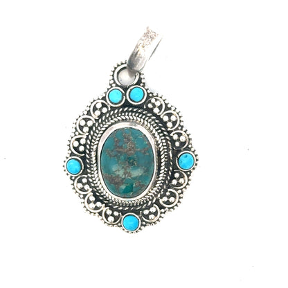 Silver pendants weighing 15.9g, unbranded, featuring intricate designs, shown in a close-up image.
