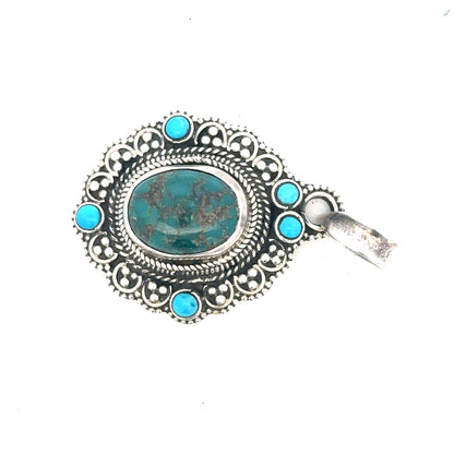 Silver pendants weighing 15.9g, unbranded, featuring intricate designs, shown on a display with a shiny silver finish.