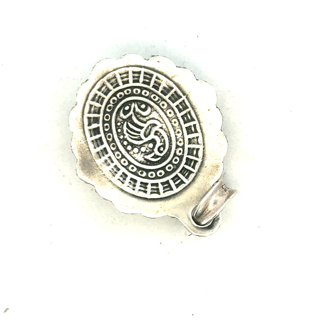 Silver pendant weighing 15.9g, unbranded, with a sleek, polished surface and intricate design details visible in the image.