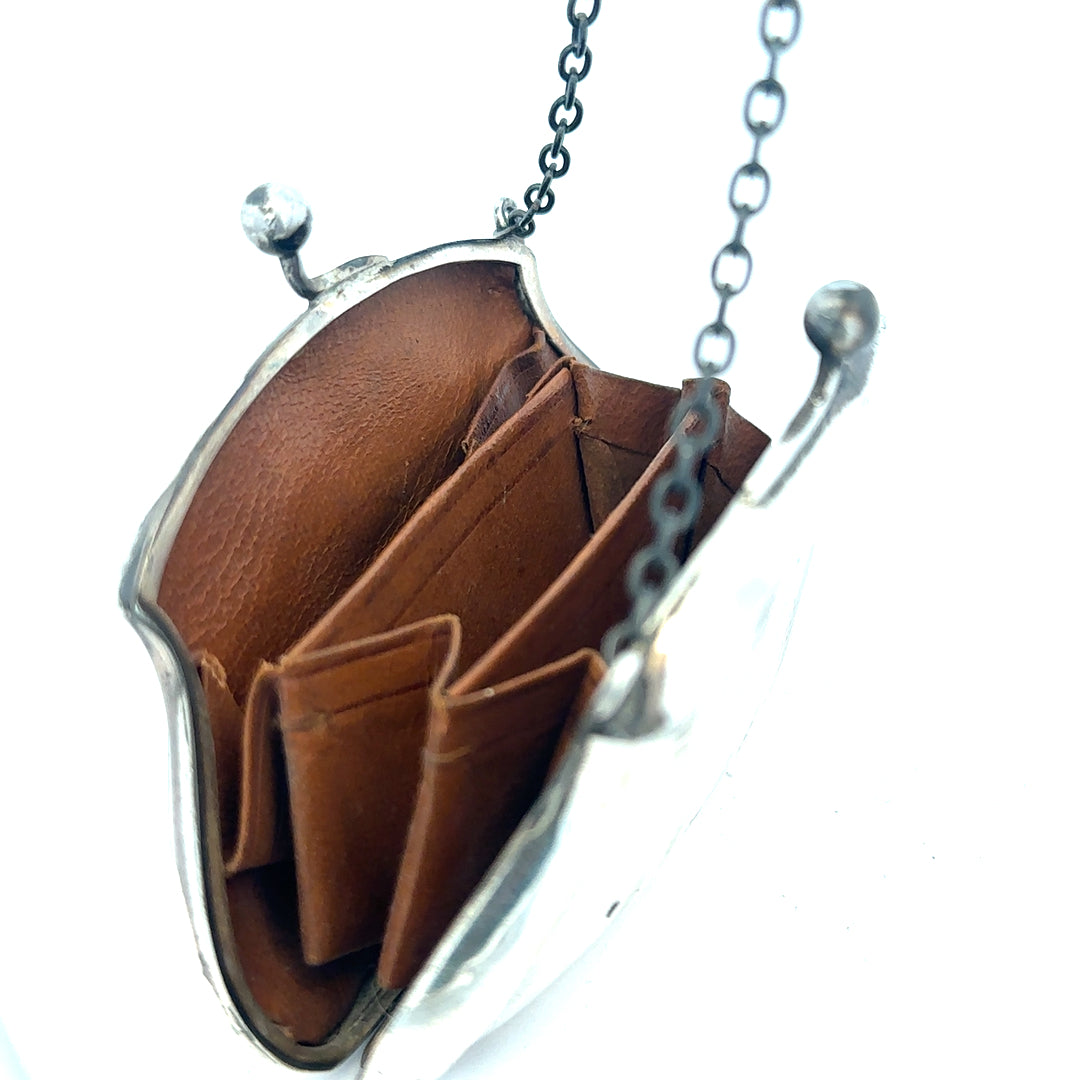 Silver purse weighing 66.2g with a sleek design, featuring a smooth surface and compact size, ideal for carrying small essentials.