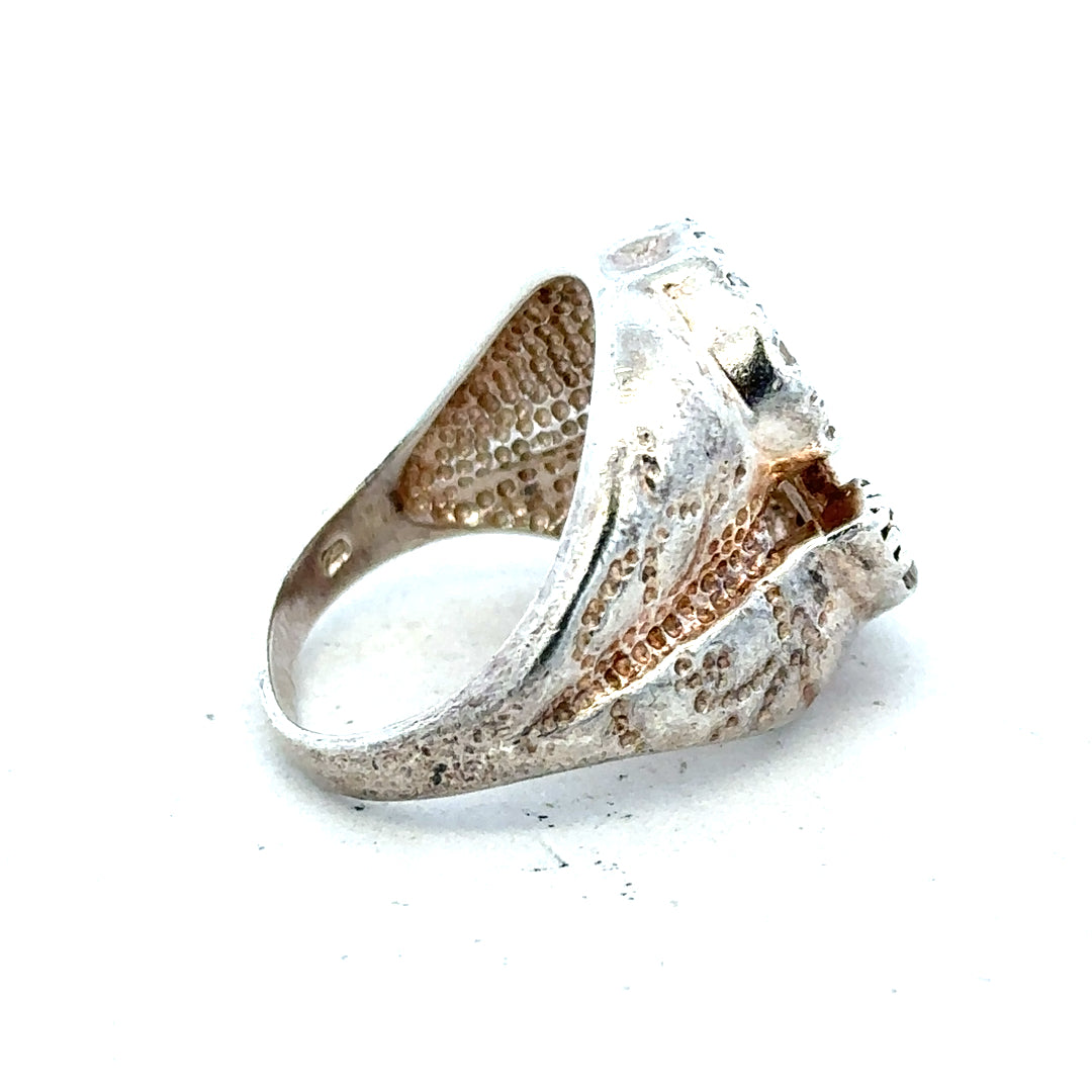 Silver ring in size R with a simple band design, displayed on a neutral background