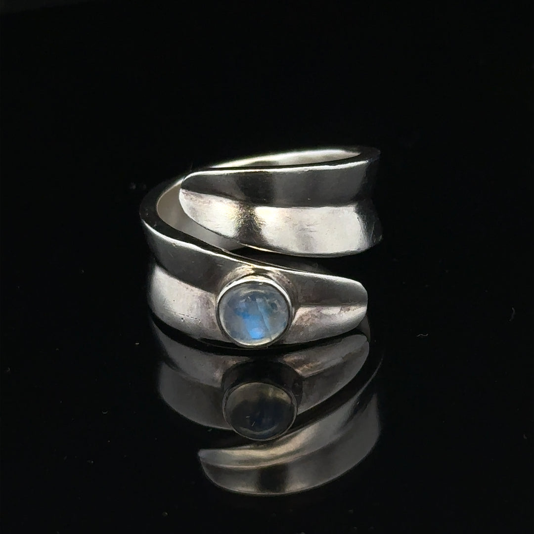 Silver ring size R with a smooth band, unbranded jewelry piece, displayed against a neutral background.