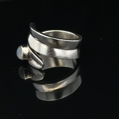 Silver ring size R with a smooth band, unbranded jewelry piece displayed on a neutral background.