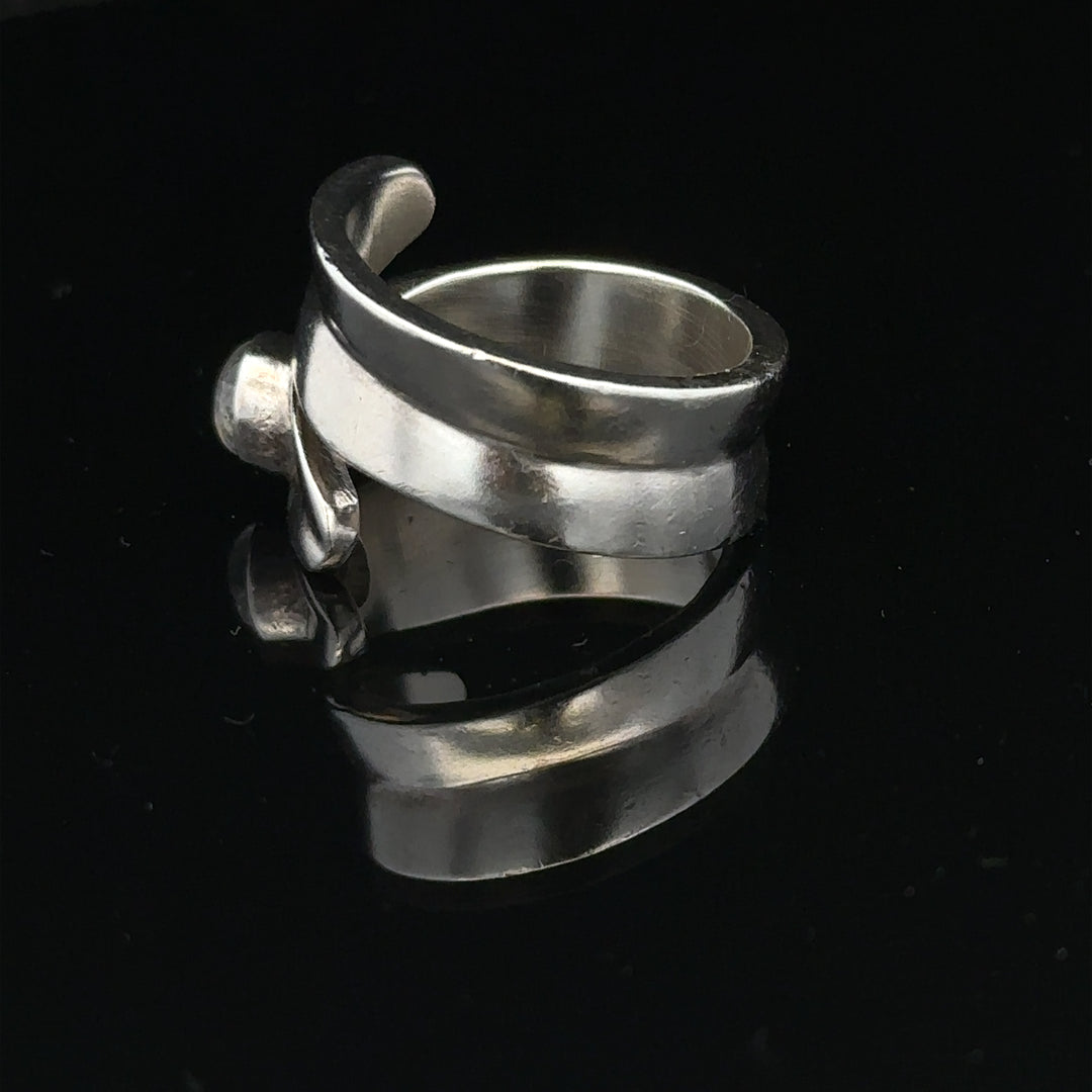 Silver ring in size R with a simple band design, unbranded jewelry piece displayed on a plain background.