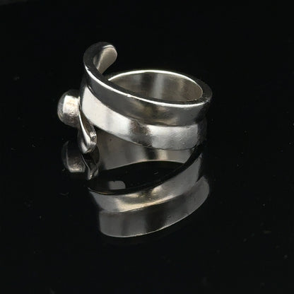 Silver ring in size R with a simple band design, unbranded jewelry piece displayed on a plain background.
