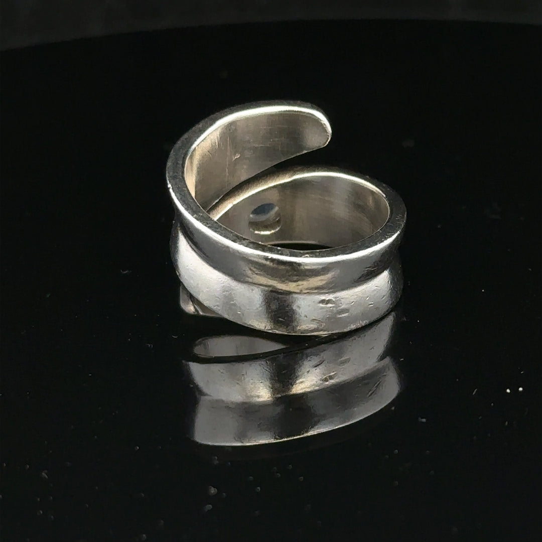 Silver ring size R with a smooth band, unbranded jewelry piece, displayed on a neutral background.