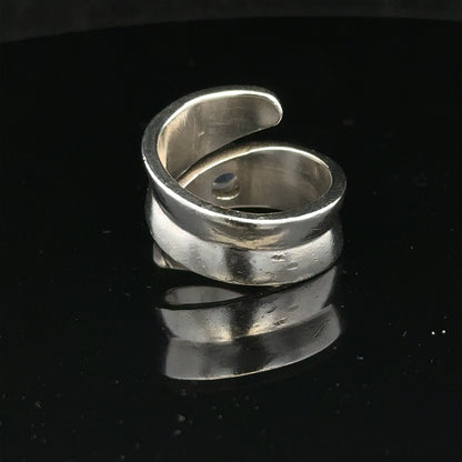 Silver ring size R with a smooth band, unbranded jewelry piece, displayed on a neutral background.